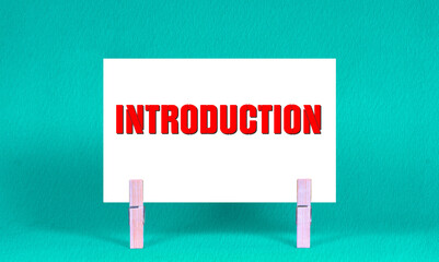 INTRODUCTION Symbol. Concept words INTRODUCTION on White Rectangle Paper Held by Wooden Clothespin...