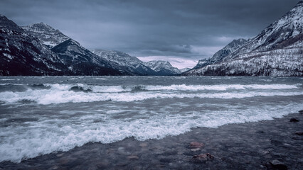 Majestic Mountain Lake with Rolling Waves Under Cloudy Sky