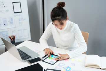 Female ux developer and ui designer , mobile app interface wireframe design. App developer working...