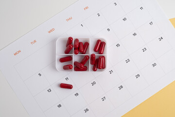 Dosage of pills by day, medication calendar, pill organizer with copy space.