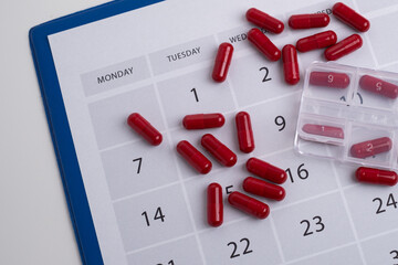 Dosage of pills by day, medication calendar, pill organizer with copy space.