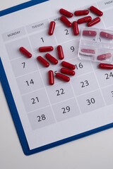 Dosage of pills by day, medication calendar, pill organizer with copy space.