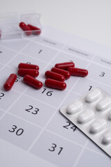 Dosage of pills by day, medication calendar, pill organizer with copy space.