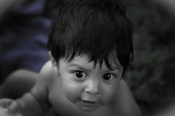 An infant staring at something off camera