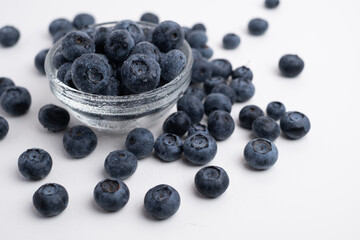 Fresh organic blueberries in a plate on a light background. Antioxidants and vitamins