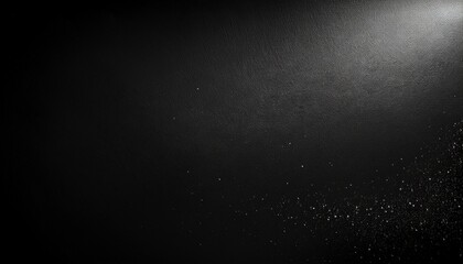 black matte textured background with floating dust particles illuminated by soft light in the top right corner creating a deep contrast between black and white this abstract design emphasizes textur