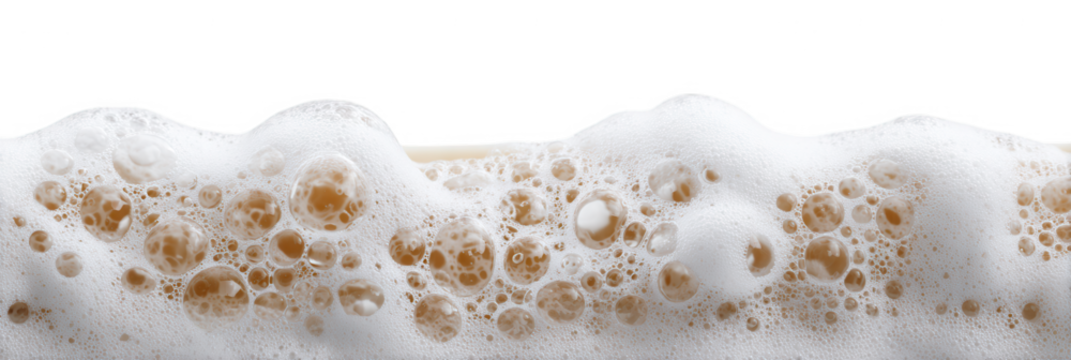 Close up of white soap foam with large and small bubbles against a black background.