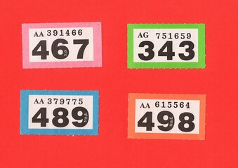 Vintage raffle tickets on a bright coloured background.