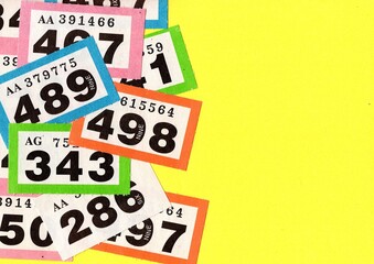 Vintage raffle tickets on a bright coloured background.