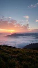 Fototapeta premium Serene Pastel Sunrise Over Misty Mountain Range