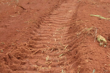 soil in the ground, Machinery Tracks Shaping Field Relief.