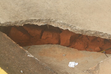 Rain-damaged asphalt collapsed