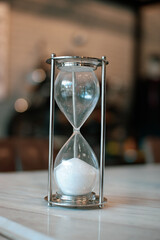 hourglass on a black background. Sandglass, hourglass or egg timer with shadow showing the last...