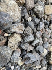 Close-up View of Various Textured Gray Stone and Gravel Ground Surface