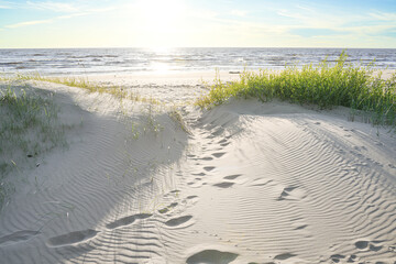 footprints in the sand towards the sea © Kaspars