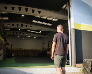 Man entering crossfit gym preparing for workout
