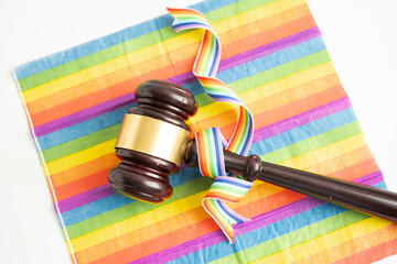 Gavel for judge lawyer on rainbow flag, symbol of LGBT pride month.