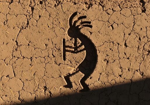 Kokopelli Carving In Adobe Wall