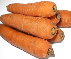 fresh raw whole carrots, a pile of carrots on a white background