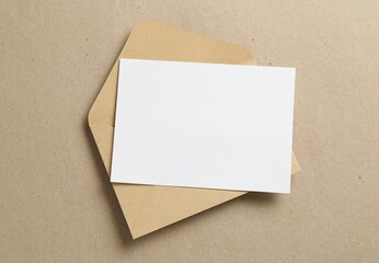 Blank invitation card and envelope on carton, top view. Space for design
