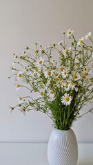 Minimalist still life with a bouquet of wild daisies in a modern white vase.