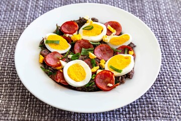 Traditional black bean tutu with kale, calabrese sausage, bacon and egg. A classic rustic dish from Minas Gerais