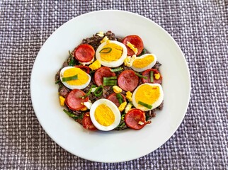 Traditional black bean tutu with kale, calabrese sausage, bacon and egg. A classic rustic dish from Minas Gerais