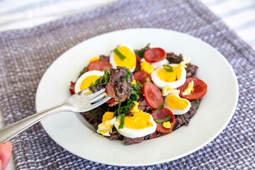 Traditional black bean tutu with kale, calabrese sausage, bacon and egg. A classic rustic dish from Minas Gerais
