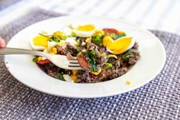 Traditional black bean tutu with kale, calabrese sausage, bacon and egg. A classic rustic dish from Minas Gerais