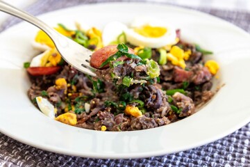 Traditional black bean tutu with kale, calabrese sausage, bacon and egg. A classic rustic dish from Minas Gerais