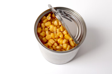 Open canned corn. Aluminum can on white background.