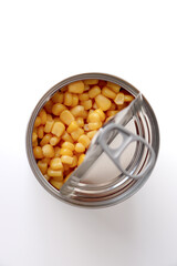 Open canned corn. Aluminum can on white background.
