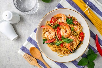 Stir Fried Spicy Spaghetti with shrimps in a white plate 