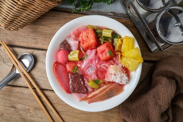 Pink Noodle Soup with meat balls and vegettable , thai called yen ta fo	