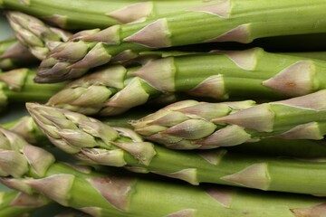 Many fresh raw asparagus spears as background, top view