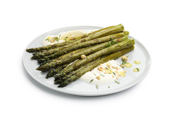 Tasty cooked asparagus with lemon and sauce isolated on white