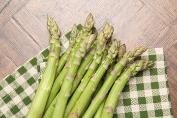 Fresh raw asparagus on wooden table, top view
