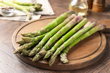 Fresh raw asparagus on wooden table, closeup