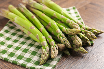 Fresh raw asparagus on wooden table, closeup