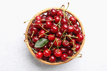 Wet ripe cherries on light table, top view