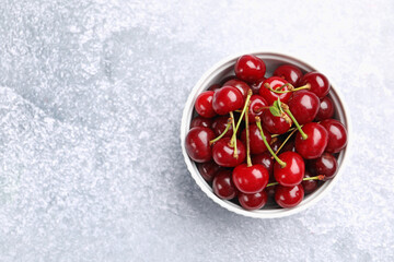 Fresh ripe cherries on light table, top view. Space for text