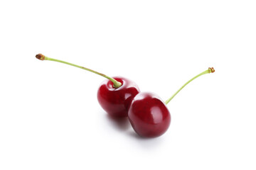 Two fresh ripe cherries isolated on white