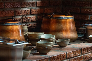 Copper pot on stove in sunlight with soup cooking, warm rustic kitchen scene and traditional meal preparation