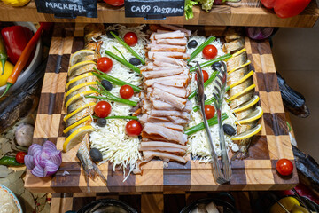 Original buffet table setup with Romanian cuisine featuring dried fish, vegetables, spreads, and...