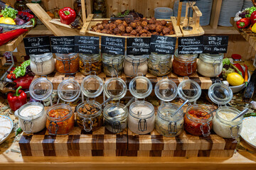 Original buffet table setup with Romanian cuisine featuring dried fish, vegetables, spreads, and...