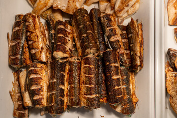 Grilled fried fish on plate in restaurant serving fresh seafood dish with garnish and elegant presentation for dining experience