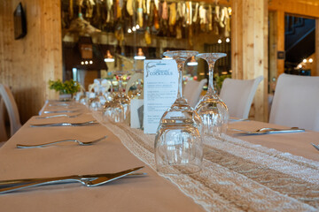 Wine glasses on table in Romanian restaurant interior, elegant dining setting with warm atmosphere...