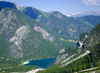 The Braies side of the Dolomites, Italy, offers breathtaking landscapes, crystal clear lakes and majestic mountains, perfect for enjoying nature.