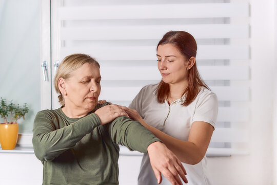 Chiropractic treatment, shoulder pain relief. Physiotherapy for senior female patient, kinesiology.