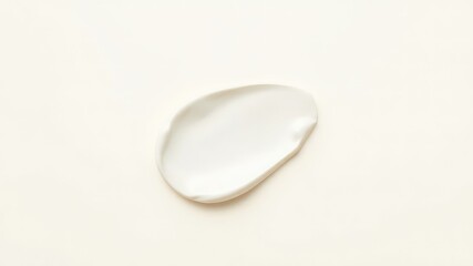 Single blob of white cream against a soft yellow backdrop, showcasing texture and the smooth, rich consistency of the product